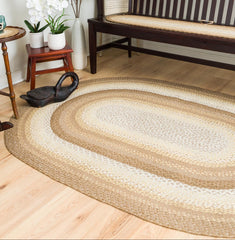 Braided jute rug in natural tan in large area rug sizes.