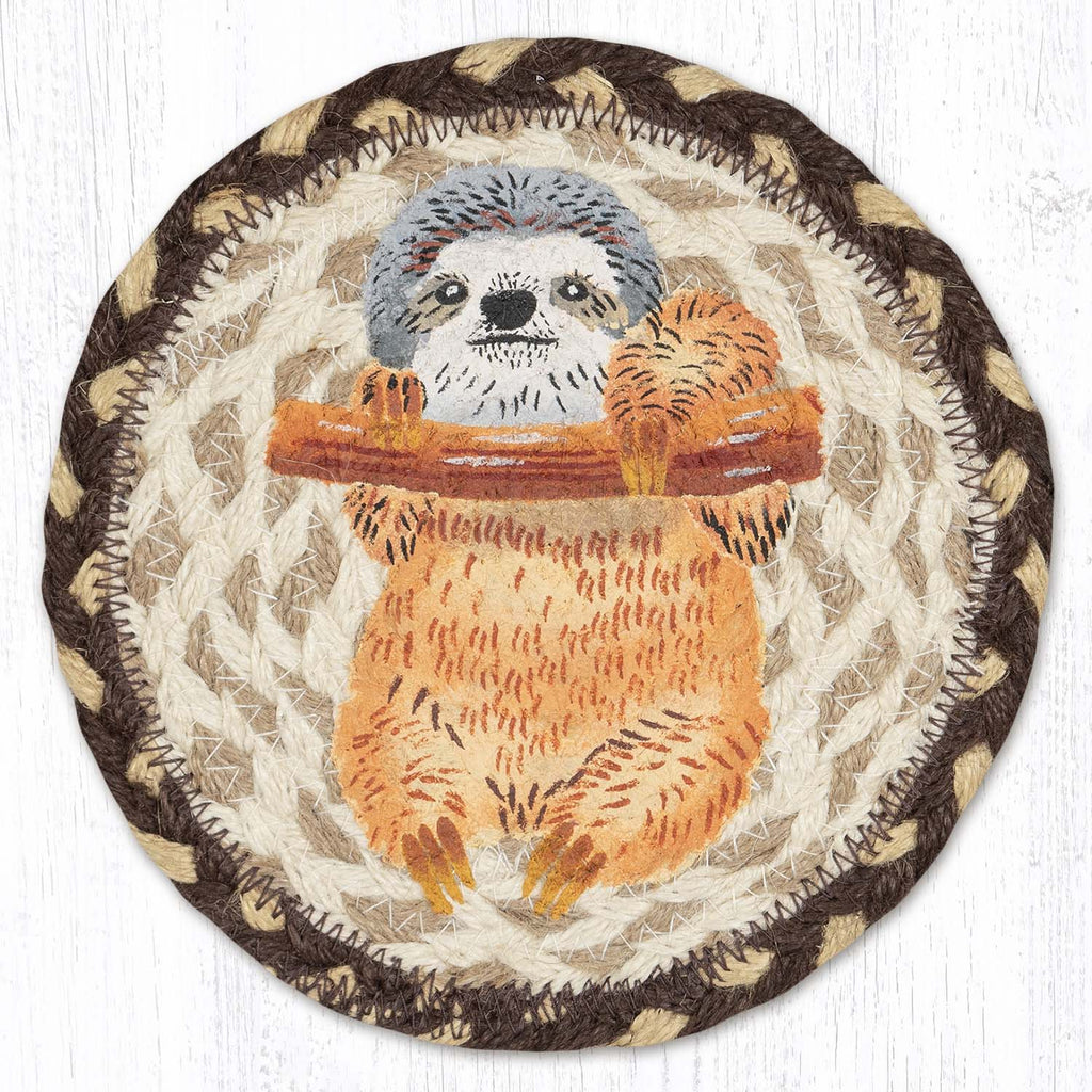 Round braided coaster with a sloth hanging on a branch design on a white background