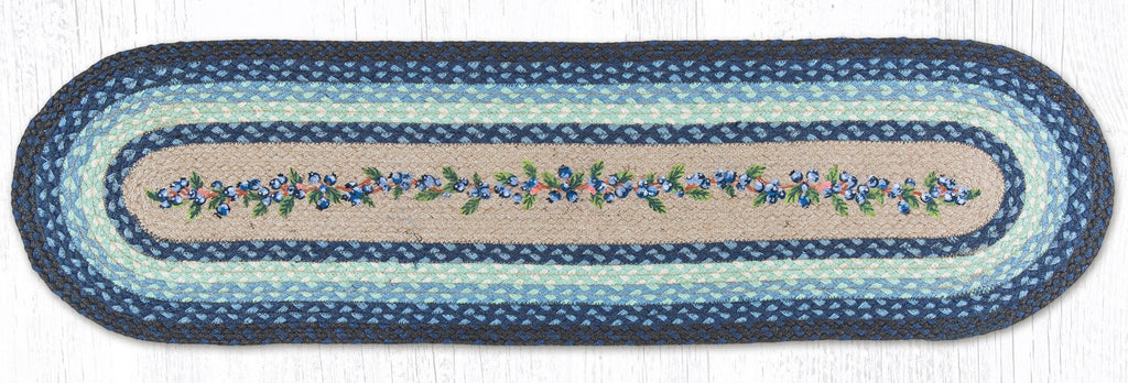 Blueberry table runner made from braided jute with blue, black, and cream colors. 