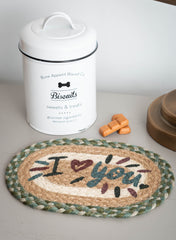 Pet placemat or trivet with "I love you" text with a metal tin of dog biscuits.