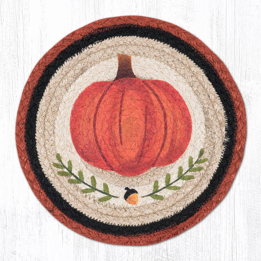 Trivet with pumpkin design with orange and black border. 