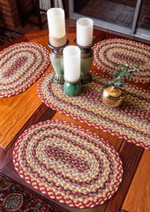 Burgundy, mustard, tan oval placemat made from braided jute 