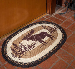 Braided rug in tans and brown with moose and tree silhouette design
